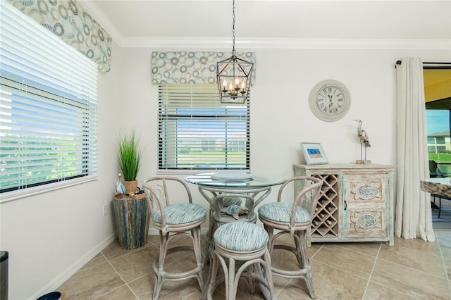 dining area with a chandelier, crown molding, baseboards, and light tile patterned floors