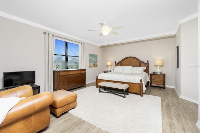 bedroom featuring light wood-style floors, ornamental molding, and baseboards