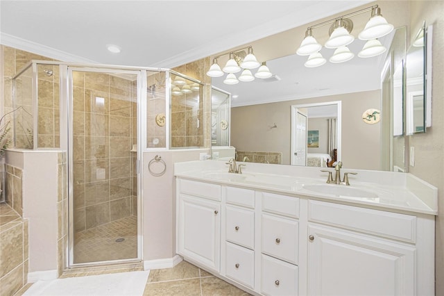 ensuite bathroom featuring tile patterned flooring, crown molding, a sink, and ensuite bathroom