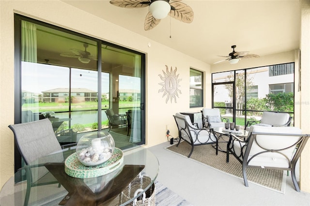 sunroom / solarium featuring ceiling fan