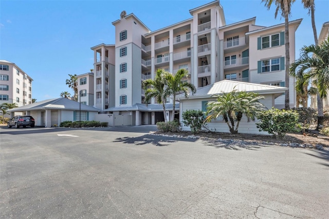 view of property with covered and uncovered parking