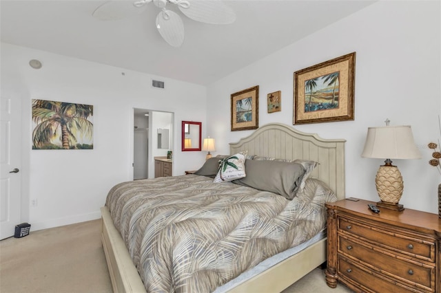 bedroom with light colored carpet, visible vents, baseboards, and ensuite bathroom