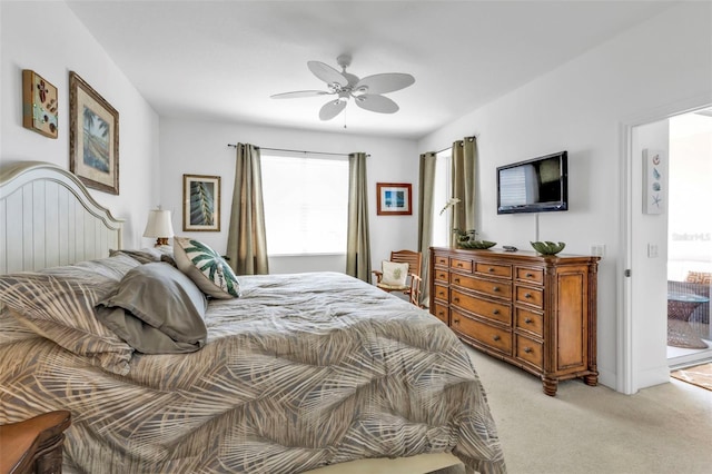 bedroom with a ceiling fan and light colored carpet