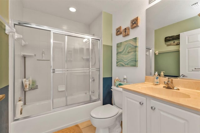 full bath featuring shower / bath combination with glass door, visible vents, toilet, vanity, and tile patterned flooring