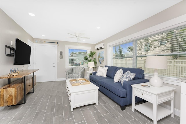 living area with recessed lighting, a ceiling fan, baseboards, an AC wall unit, and wood tiled floor