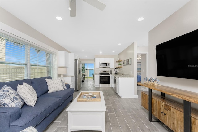 living room with wood finish floors, ceiling fan, and recessed lighting