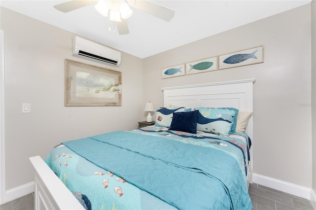 bedroom with a ceiling fan, a wall mounted air conditioner, and baseboards