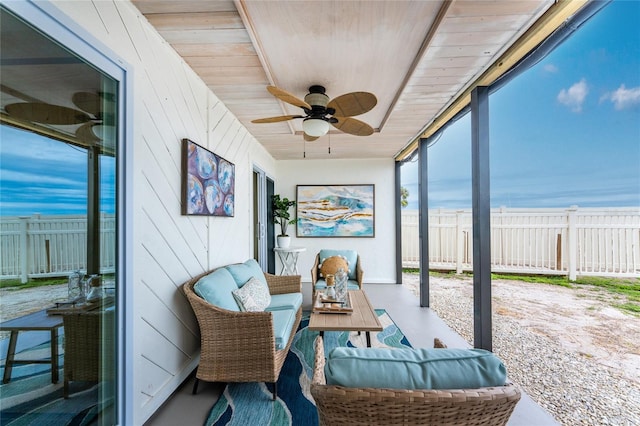 sunroom / solarium with wood ceiling and a ceiling fan