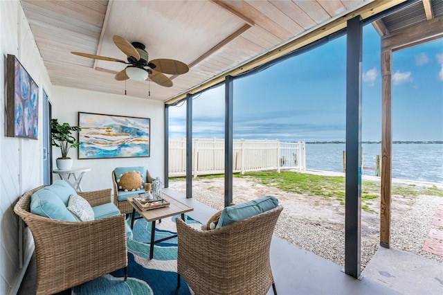 sunroom / solarium featuring wooden ceiling, visible vents, a water view, and ceiling fan