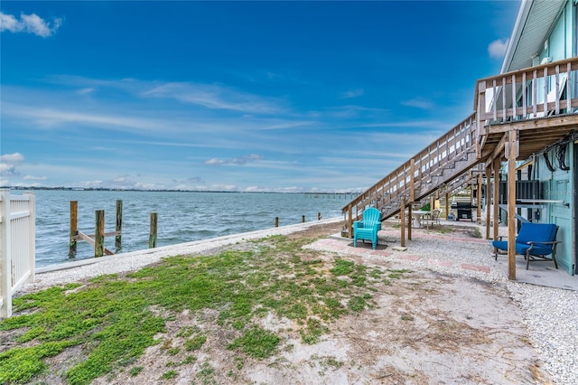 exterior space featuring a water view, a dock, and stairway