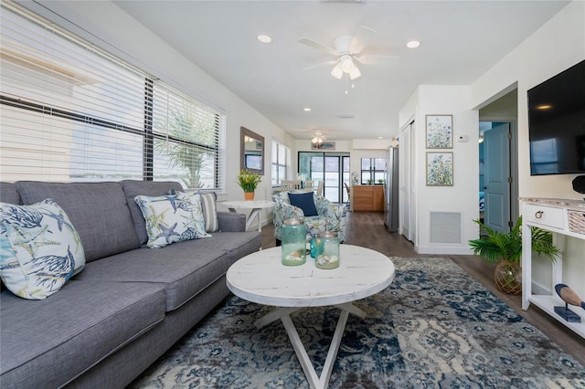 living area featuring a ceiling fan, recessed lighting, visible vents, and wood finished floors