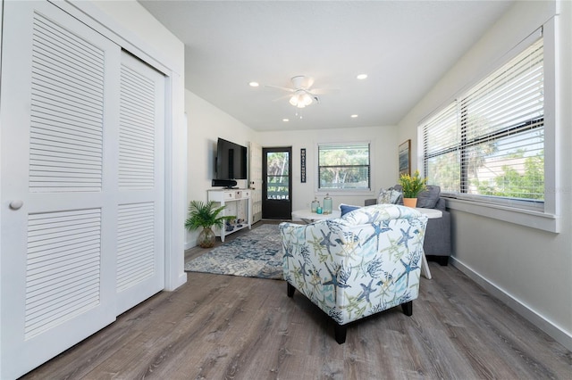 living room with recessed lighting, baseboards, and wood finished floors