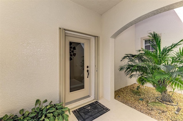 view of exterior entry with stucco siding