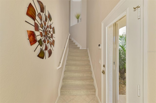 stairway featuring baseboards