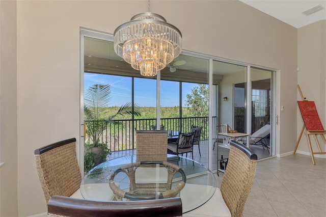 dining area featuring a chandelier, light tile patterned floors, visible vents, and baseboards