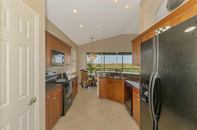 kitchen featuring dark countertops, brown cabinets, vaulted ceiling, and black appliances