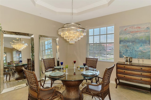 dining area with a notable chandelier, light tile patterned floors, a raised ceiling, ornamental molding, and baseboards