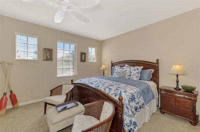 carpeted bedroom with a ceiling fan and baseboards