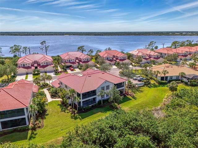 drone / aerial view featuring a water view and a residential view