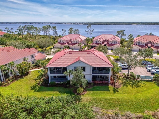 drone / aerial view featuring a residential view and a water view