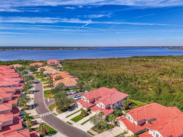 drone / aerial view featuring a residential view and a water view