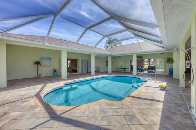 outdoor pool featuring a lanai, a ceiling fan, and a patio