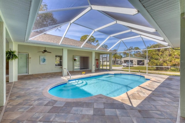 outdoor pool featuring a lanai, ceiling fan, and a patio