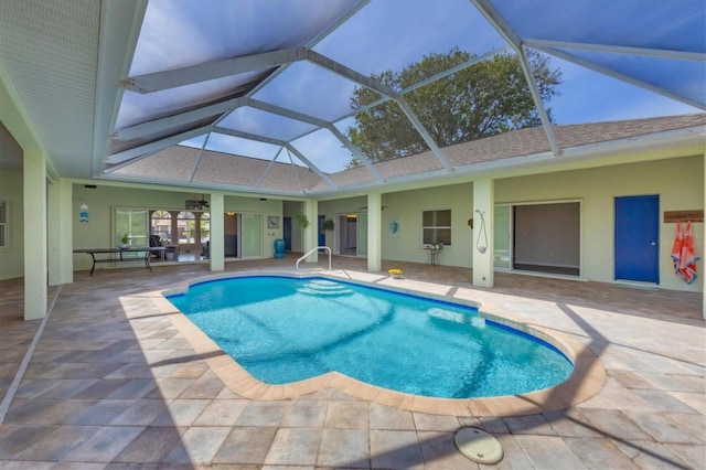 pool with a lanai and a patio