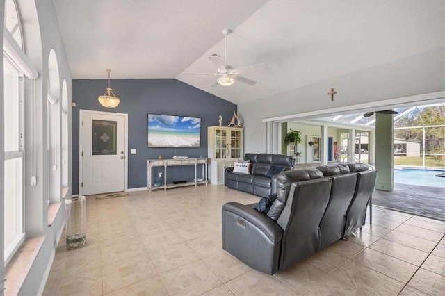 living room featuring lofted ceiling, ceiling fan, and light tile patterned flooring