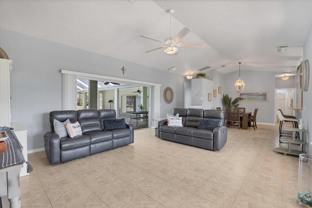 living room with a ceiling fan, vaulted ceiling, baseboards, and light tile patterned floors