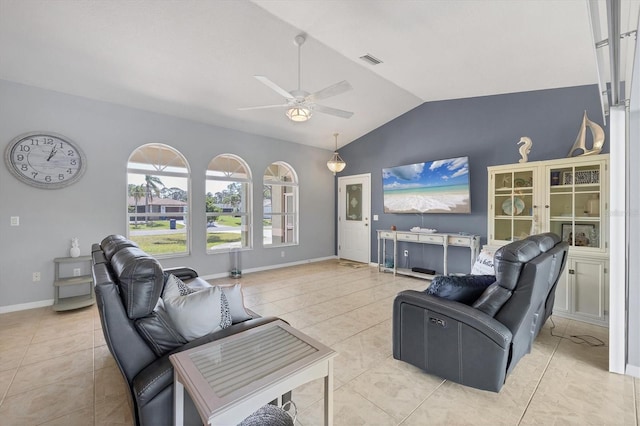 living area with visible vents, a ceiling fan, light tile patterned flooring, vaulted ceiling, and baseboards