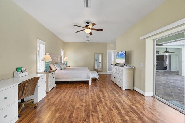 bedroom with ceiling fan, dark wood-style flooring, visible vents, and baseboards