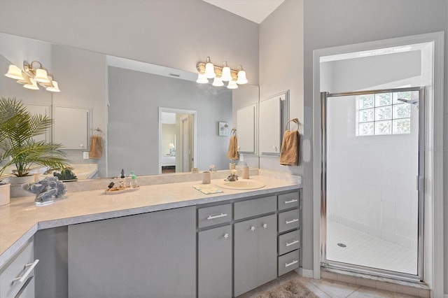 bathroom with a stall shower, tile patterned floors, and vanity