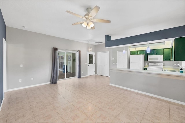 unfurnished room featuring a sink, baseboards, and ceiling fan