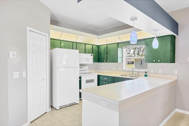 kitchen featuring light countertops, white appliances, a peninsula, and green cabinetry