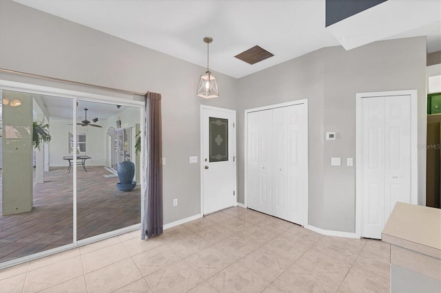 entrance foyer featuring a ceiling fan, baseboards, and light tile patterned floors