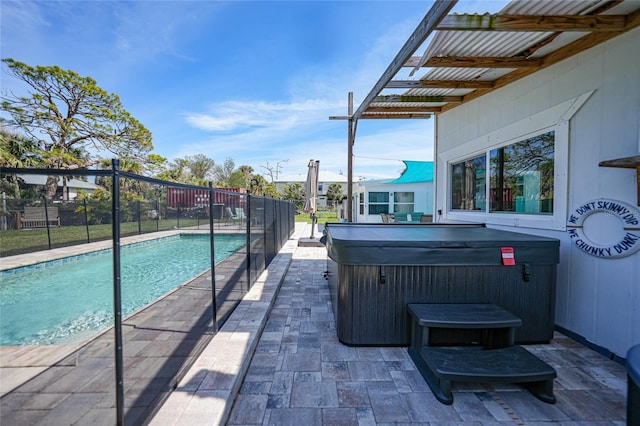 view of swimming pool with a patio area, a hot tub, fence, and a fenced in pool