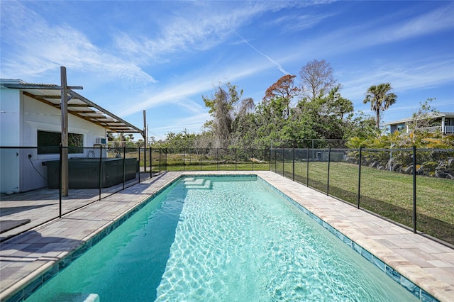 view of swimming pool with a patio, fence, a lawn, a fenced in pool, and a hot tub