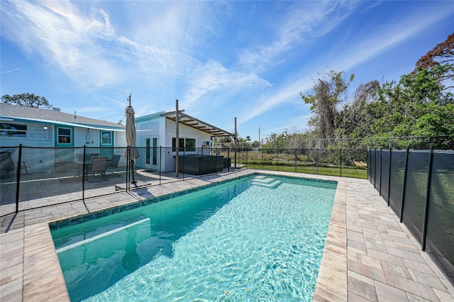 view of swimming pool with a patio, fence, and a fenced in pool