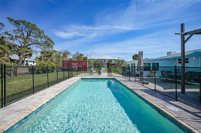 view of pool featuring a fenced in pool, a lawn, fence, and a patio