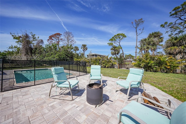 view of patio featuring a fenced in pool, an outdoor fire pit, and fence