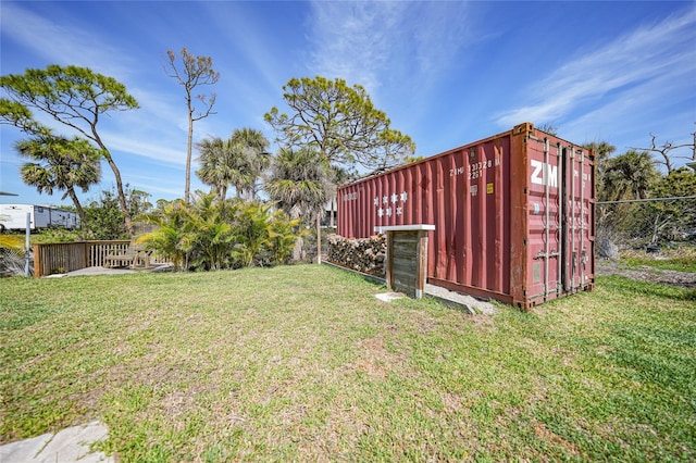 view of yard with an outbuilding and fence