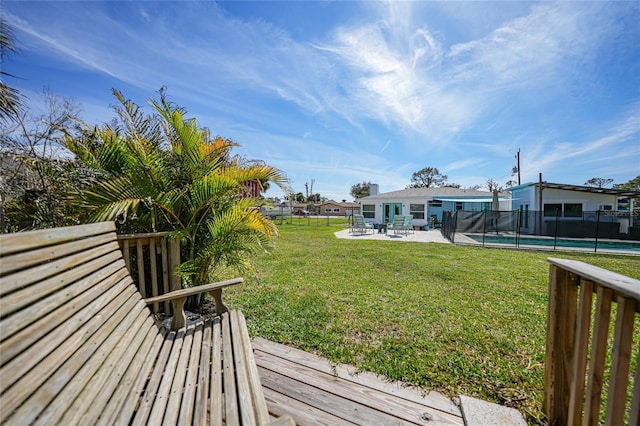 view of yard featuring a fenced in pool, fence, and a patio