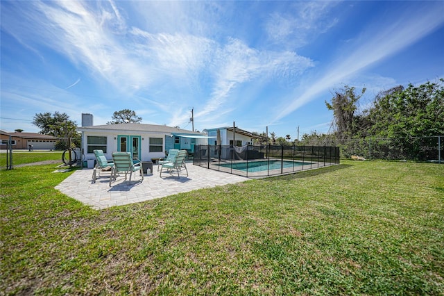 back of property featuring a fenced in pool, french doors, a yard, a patio, and a fenced backyard