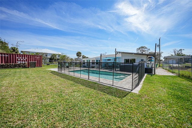 view of pool featuring a fenced in pool, a lawn, and fence