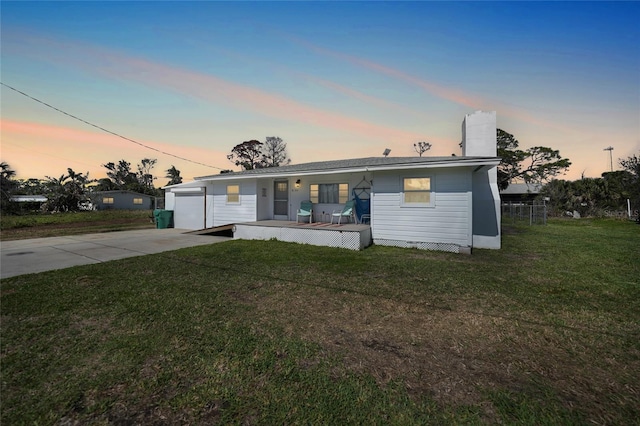 view of front of property with a garage, a porch, concrete driveway, and a yard