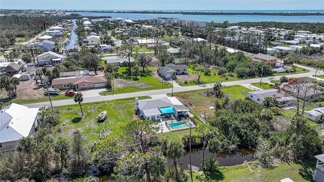 drone / aerial view featuring a residential view and a water view