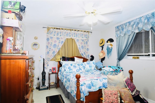 bedroom featuring a ceiling fan and light colored carpet