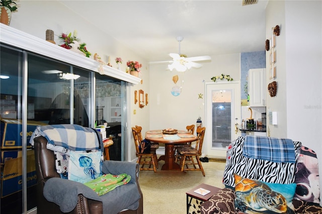 living room with ceiling fan and visible vents