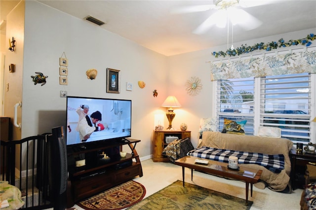 living area with baseboards, carpet, visible vents, and a ceiling fan